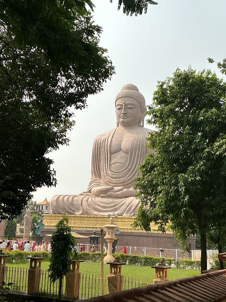 Sarnath — the giant seated Buddha statue among trees, one of the modern temples around the site